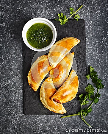 Empanadas with chimichuri sauce. Traditional Latin American cuisine Stock Photo