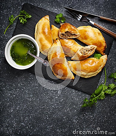 Empanadas with chimichuri sauce. Traditional Latin American cuisine Stock Photo