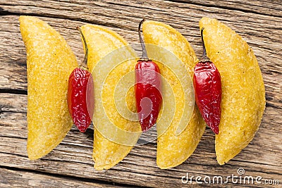 Empanadas and hot pepper on wooden background, traditional Colombian food Stock Photo