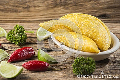 Empanadas and hot pepper on wooden background, traditional Colombian food Stock Photo