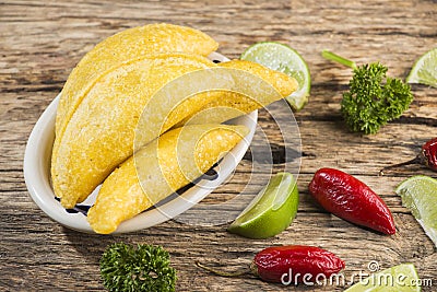 Empanadas and hot pepper on wooden background, traditional Colombian food Stock Photo