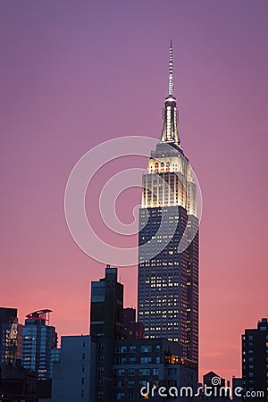 Empire state building with bright purple sky at sunset - New York city Editorial Stock Photo