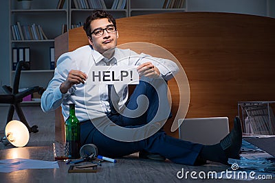 The employee asking for help and drinking under stress and despair Stock Photo