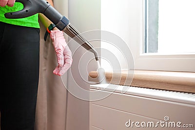 Employee cleaning service processes steam heating radiator Stock Photo