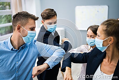 Employee Doing Elbow Bump To Avoid Flu Stock Photo