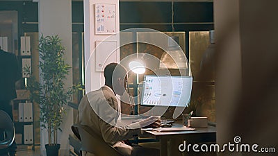 Employee enjoys coffee during nightshift Stock Photo