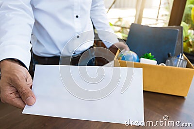 Employee holding resignation letter and Packing a Box To Leave The Office Stock Photo