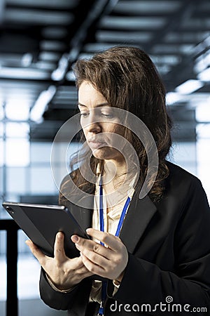 Employee uses device to review firewall rules, enforcing cybersecurity protocols Stock Photo