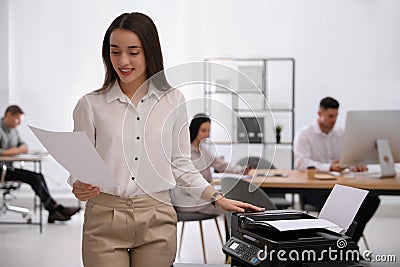 Employee using new modern printer in office Stock Photo