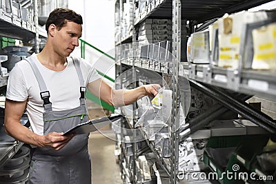 Employees of a car repair shop in a warehouse for spare parts Stock Photo