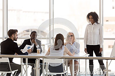 Employees discuss project at company business briefing Stock Photo