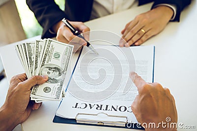 Employees are doing corruption by giving dirty money to signing contract Stock Photo