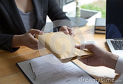 Employees give money to bribe with the chief. To be promoted Stock Photo
