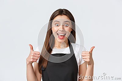 Employees, job employment, small business and coffee shop concept. Satisfied cute female saleswoman in black apron Stock Photo