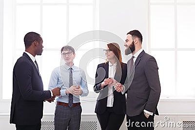 Multiethnic corporate meeting of successful managers in formal wear in office, business people with copy space Stock Photo