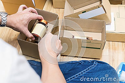 Employees are packing a parcel in the send to the customer. Stock Photo