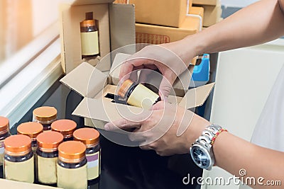 Employees are packing a parcel in the send to the customer. Stock Photo