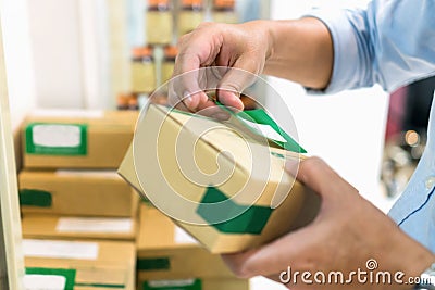 Employees are packing a parcel in the send to the customer. Online ordering For the convenience of customers. Stock Photo