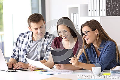 Employees working on line with tablet at office Stock Photo