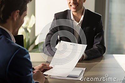 Employer conducting job interview, reviewing good resume of succ Stock Photo