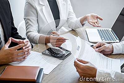 Employer or recruiter holding reading a resume with talking during about his profile of candidate, employer in suit is conducting Stock Photo