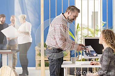 Employer showing a magazine Stock Photo