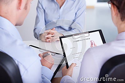 Employers checking curriculum vitae Stock Photo