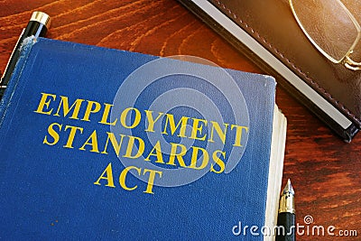 Employment standards act and glasses. Stock Photo