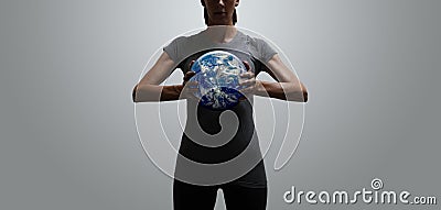 Empowered fit woman holding world in her hands Stock Photo