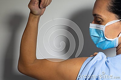 Empowered nurse, the nurse shows her biceps Stock Photo