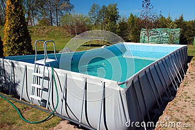 Empty above ground swimming pool in a backyard Stock Photo