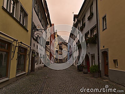 Empty alley with old buildings in town center on cloudy winter day. Orange colored sky due to weather phenomenon. Editorial Stock Photo