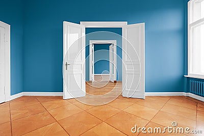 Empty apartment room with blue walls and parquet floor Stock Photo