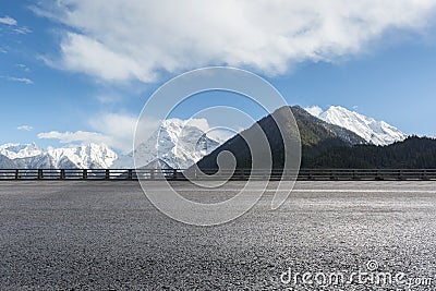 Empty asphalt highway with snow mountain background Stock Photo