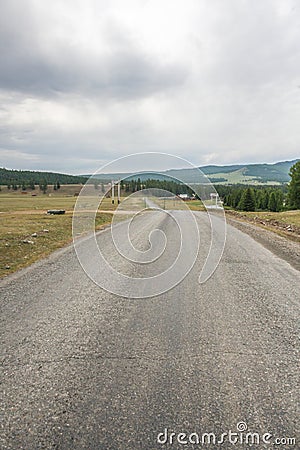 Empty asphalt road leading to mountains Stock Photo