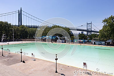 Empty Astoria Park Pool during Summer with the Triborough Bridge in the Background in Astoria Queens New York Editorial Stock Photo