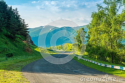 Empty automobile mountain road on a sunny summer day in the picturesque mountains of Transcaucasia Stock Photo