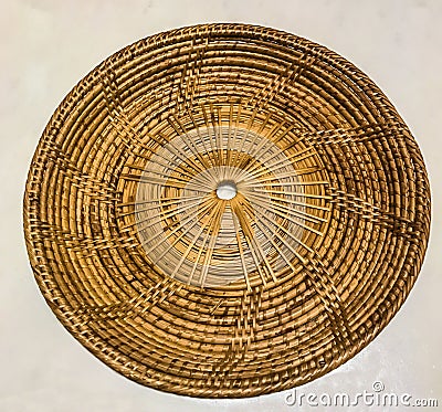 Empty bamboo rattan woven tray place mat on the white marble table background Stock Photo