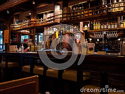 Empty bar counter at The Public Izakaya Japanese restaurant in Tanjong Pagar, Singapore in the evening Editorial Stock Photo
