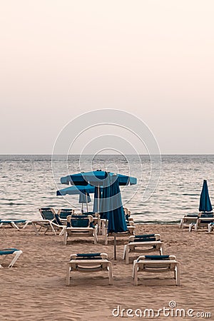 Empty beach, with hammocks and parasols, cloudy day Stock Photo