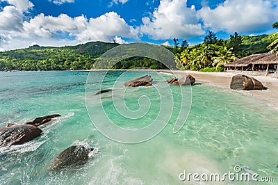 Empty Beach in Seychelles, Mahe island. Rocks and Palm trees in background. Indian Ocean. Stock Photo