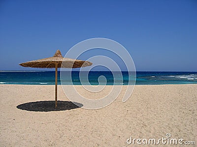 Empty beach with sunshade Stock Photo