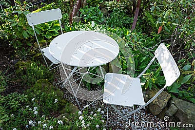 Empty bistro coffee table with chairs in garden Stock Photo