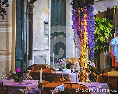 Empty bistro dinner first date restaurant design romantic outdoor purple flowers Stock Photo