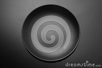 Empty black plate on a dark gradient background Stock Photo