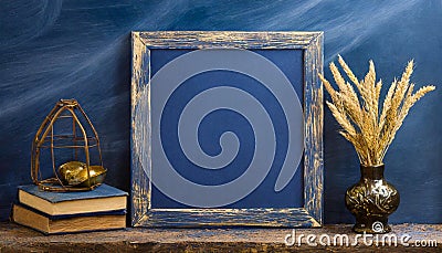 Empty blackboard with vase and dried flowers on dark blue background Stock Photo