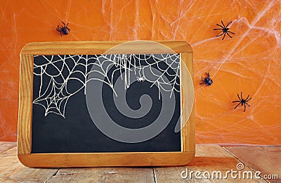 Empty blackboard on wooden table. Halloween concept Stock Photo