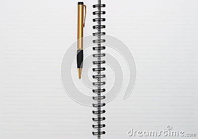 Empty blank ring, spiral notepad, one gold pen Stock Photo