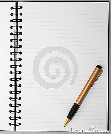Empty blank ring, spiral notepad, one gold pen Stock Photo