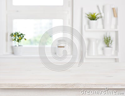 Empty bleached wooden table and kitchen window shelves blurred background Stock Photo